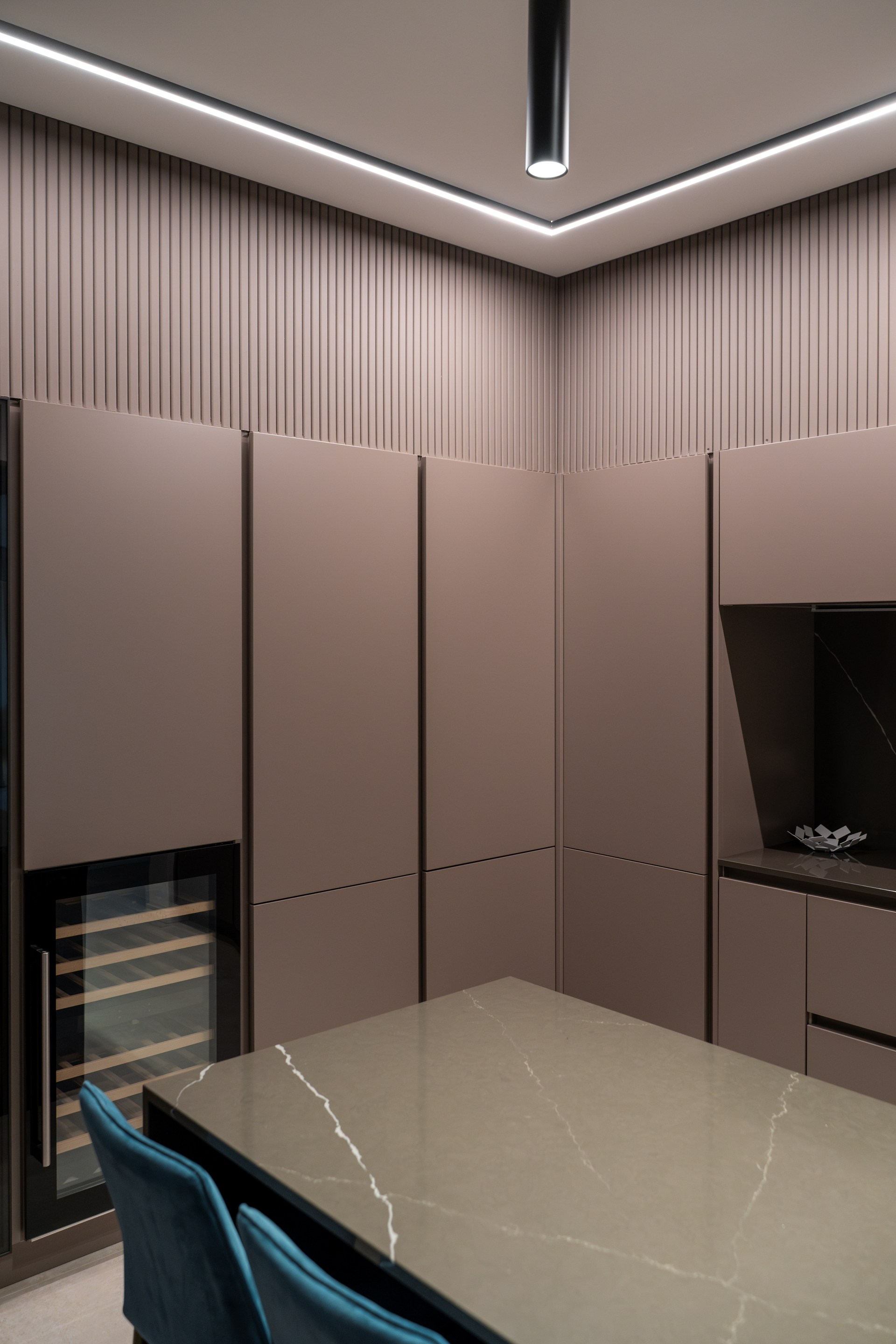 Integrated ceiling lighting profiles outlining the space with clean geometry and indirect illumination.